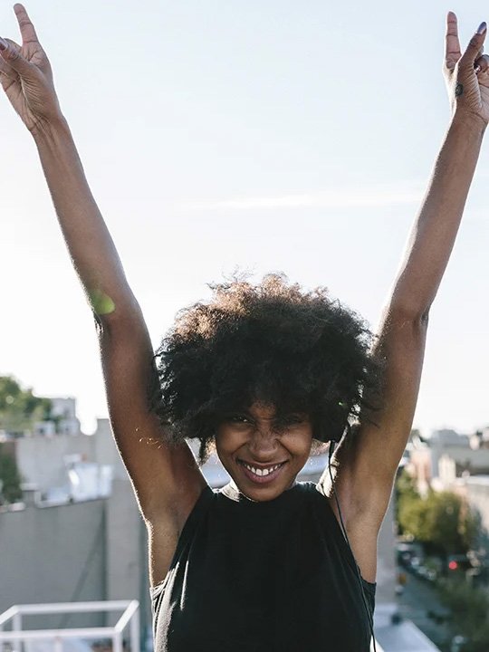 Woman smiling and lifting hands up