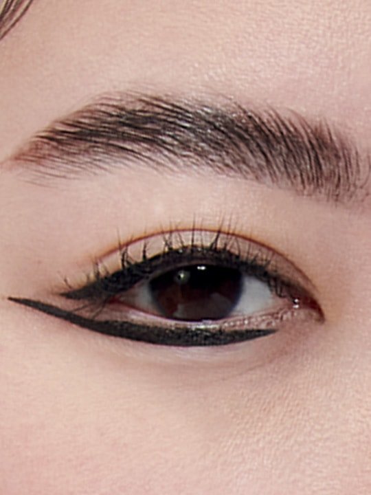 close-up of model wearing fishtail eyeliner makeup
