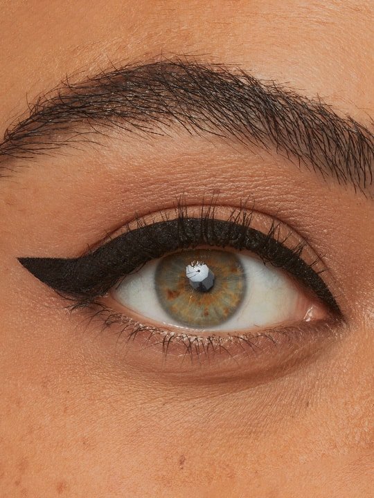 close up of model wearing thick winged eyeliner