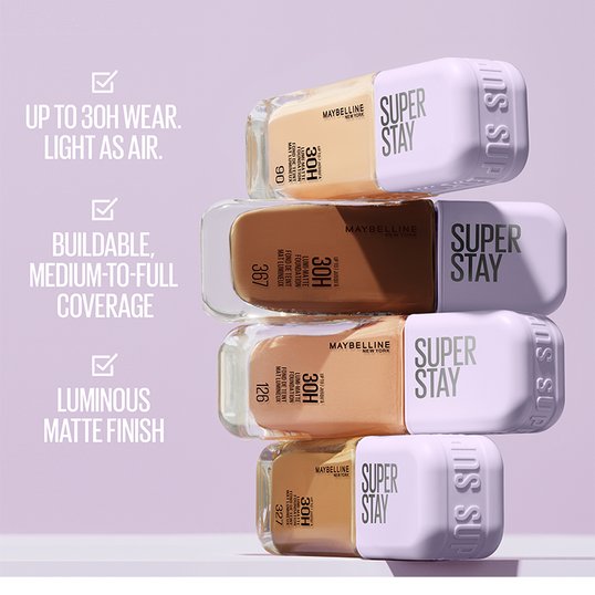 Promotional shot showcasing the benefits of Maybelline’s Super Stay 30h Lumi-Matte Foundation. Text reads: UP TO 30H WEAR. LIGHT AS AIR./ BUILDABLE. MEDIUM-TO-FULL COVERAGE/ LUMINOUS MATTE FINISH.