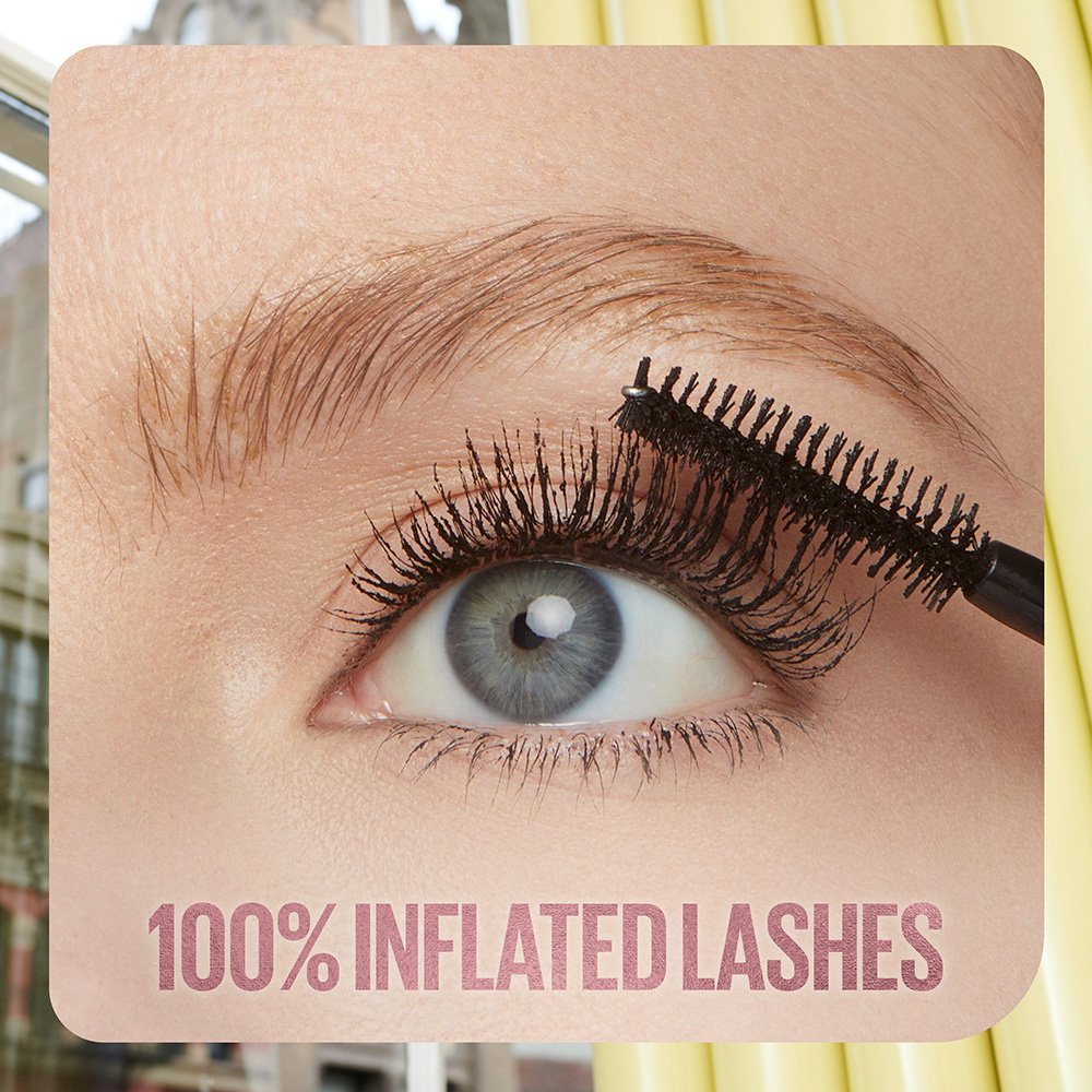 A close-up image of a woman applying lengthening mascara